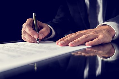 Attorney signing legal paperwork